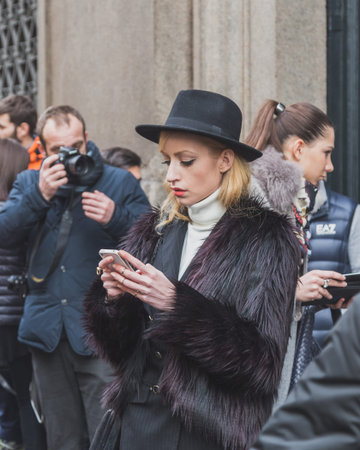 MILAN, ITALY - JANUARY 20: People gather outside Cavalli fashion show building for Milan Men's Fashion Week on JANUARY 20, 2015 in Milan.のeditorial素材
