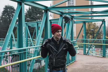 Punk guy with beanie posing in the city streetsの写真素材