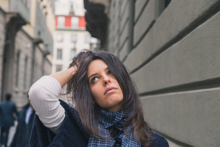 Beautiful girl with long hair posing in the city streets