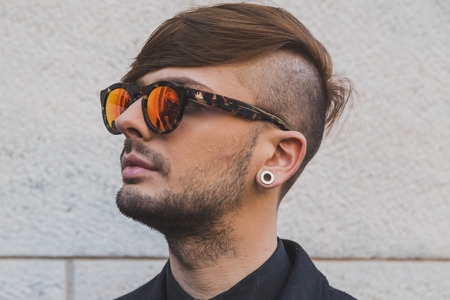 MILAN, ITALY - FEBRUARY 26: Man poses outside Cristiano Burani fashion show building for Milan Women's Fashion Week on FEBRUARY 26, 2015  in Milan.のeditorial素材