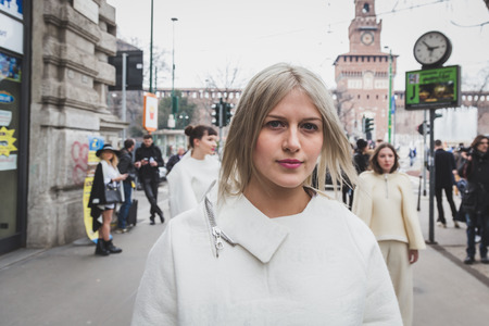 MILAN, ITALY - FEBRUARY 28: People gather outside Jil Sander fashion show building for Milan Women's Fashion Week on FEBRUARY 28, 2015  in Milan.のeditorial素材