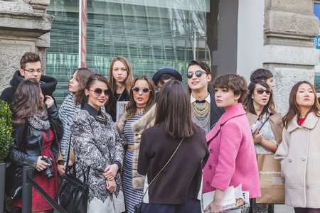 MILAN, ITALY - FEBRUARY 28: People gather outside Jil Sander fashion show building for Milan Women's Fashion Week on FEBRUARY 28, 2015  in Milan.のeditorial素材