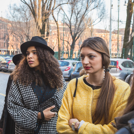 MILAN, ITALY - MARCH 2: Girls wait outside Alberto Zambelli fashion show building for Milan Women's Fashion Week on MARCH 2, 2015  in Milan.のeditorial素材