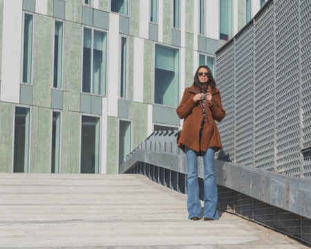 Beautiful girl with long hair posing in an urban context