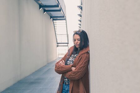 Beautiful girl with long hair posing in an urban contextの写真素材