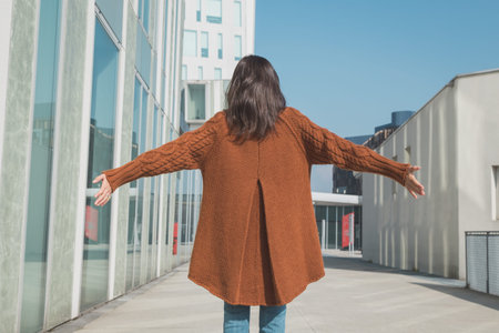 Beautiful girl with long hair posing in an urban context