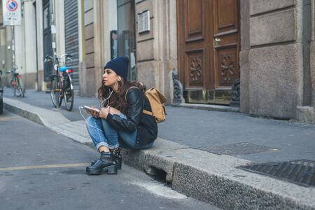 Beautiful Middle Eastern girl with long hair posing in an urban contextの写真素材