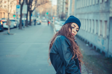 Beautiful Middle Eastern girl with long hair posing in an urban context