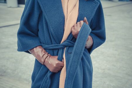 Detail of a stylish young woman posing in the city streetsの写真素材