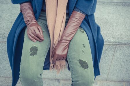 Detail of a stylish young woman posing in the city streetsの写真素材