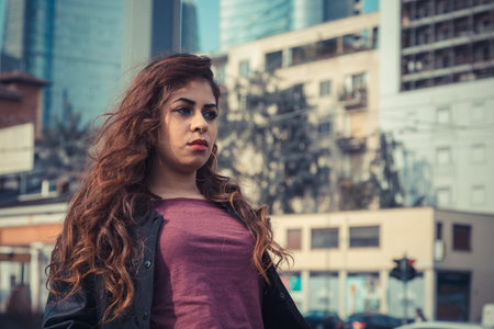 Beautiful Middle Eastern girl with long hair posing in an urban context