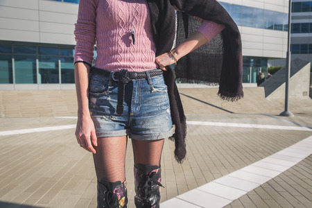 Detail of a beautiful young woman with over the knee boots standingの写真素材