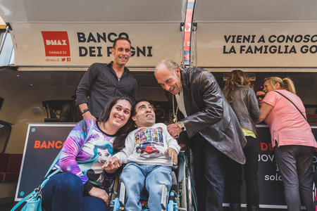 MILAN, ITALY - APRIL 18: Les and Seth Gold of the tv series Hardcore Pawn pose with a guy on wheelchair at Fuorisalone, important and interesting events all around the town during Milan Design Week on APRIL 18, 2015 in Milan.のeditorial素材