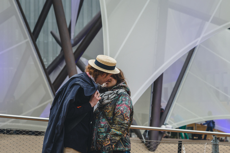 MILAN, ITALY - MAY 1: Couple kissing at Expo, universal exposition on the theme of food on MAY 1, 2015 in Milan.のeditorial素材