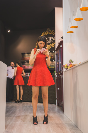 MILAN, ITALY - MAY 4: Pretty girl working at Tuttofood, world food exhibition on MAY 4, 2015 in Milan.のeditorial素材