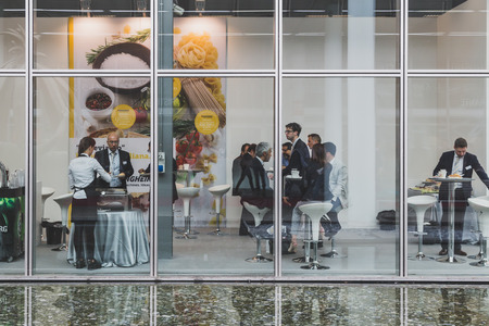 MILAN, ITALY - MAY 4: People eating at Tuttofood, world food exhibition on MAY 4, 2015 in Milan.のeditorial素材