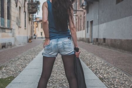 Detail of a young beautiful woman posing in the city streetsの写真素材