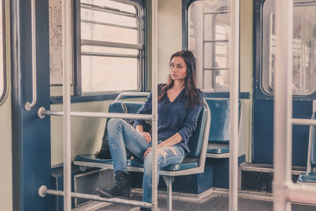 Beautiful young brunette  posing in a metro car