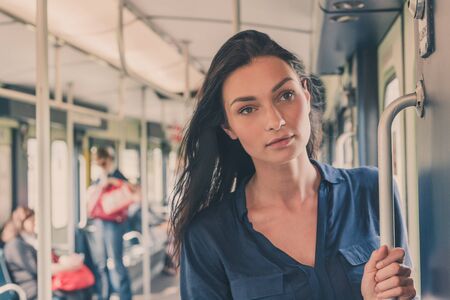 Beautiful young brunette  posing in a metro carの写真素材