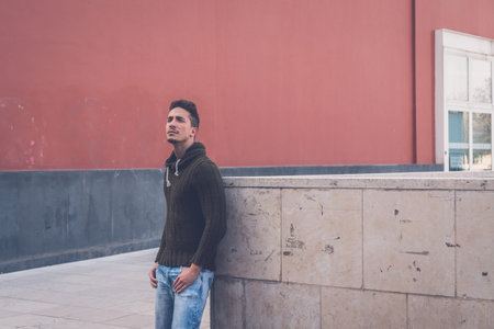 Young handsome man with short hair posing in an urban context
