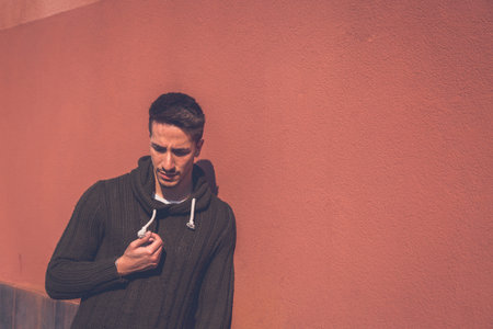 Young handsome man with short hair posing in an urban context