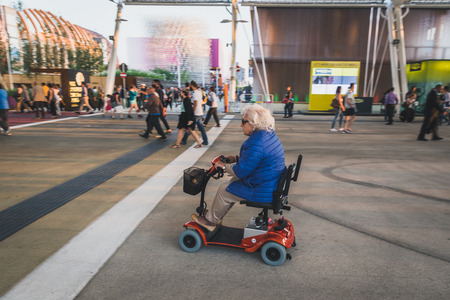 MILAN, ITALY - MAY 27: Elderly woman on electric mobility scooter at  Expo, universal exposition on the theme of food on MAY 27, 2015 in Milan.のeditorial素材
