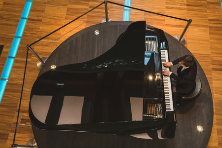 MILAN, ITALY - MAY 27: Top view of pianist performing inside Hungary pavilion at Expo, universal exposition on the theme of food on MAY 27, 2015 in Milan.のeditorial素材