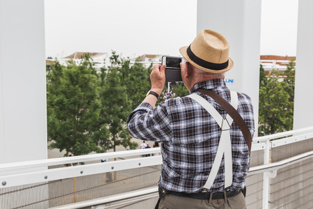 MILAN, ITALY - JUNE 1: Man with hat takes a picture at Expo, universal exposition on the theme of food on JUNE 1, 2015 in Milan.のeditorial素材