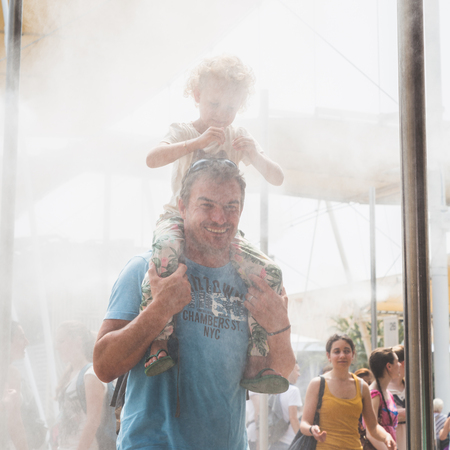 MILAN, ITALY - JUNE 5: People enjoy vaporized water outside USA pavilion at Expo, universal exposition on the theme of food on JUNE 5, 2015 in Milan.のeditorial素材