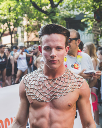 MILAN, ITALY - JUNE 27: People at gay pride parade in Milan JUNE 27, 2015. Thousands of people march in the city streets for the annual gay pride parade, claiming equality and legal rights.のeditorial素材