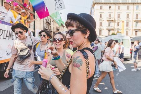MILAN, ITALY - JUNE 27: People at gay pride parade in Milan JUNE 27, 2015. Thousands of people march in the city streets for the annual gay pride parade, claiming equality and legal rights.のeditorial素材