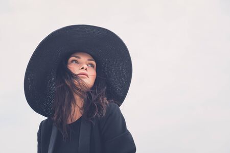 Gorgeous young brunette with hat posing in an urban contextの写真素材