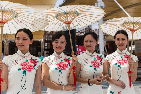 MILAN, ITALY - AUGUST 3: Beautiful Chinese girls pose outside China pavilion at Expo, universal exposition on the theme of food on AUGUST 3, 2015 in Milan.のeditorial素材