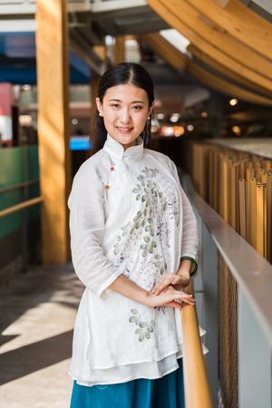 MILAN, ITALY - AUGUST 3: Beautiful Chinese girl poses outside China pavilion at Expo, universal exposition on the theme of food on AUGUST 3, 2015 in Milan.のeditorial素材