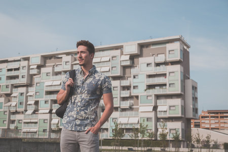 Young handsome man with short hair wearing a short sleeve shirt and posing in an urban contextの写真素材