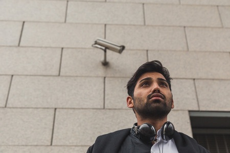 Portrait of a young handsome Indian man posing in an urban contextの写真素材