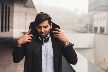 Portrait of a young handsome Indian man posing in an urban contextの写真素材