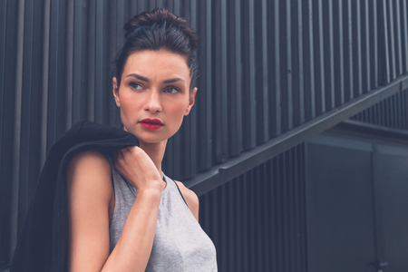 Gorgeous young brunette in black skirt posing in an urban contextの写真素材