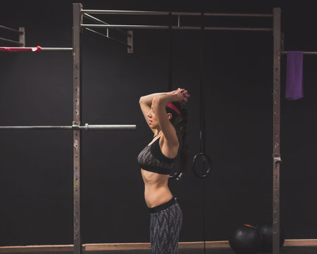 Beautiful young girl doing workout in the gym. Concept of health and fitness.