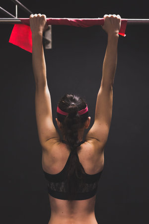 Beautiful young girl doing workout in the gym. Concept of health and fitness.