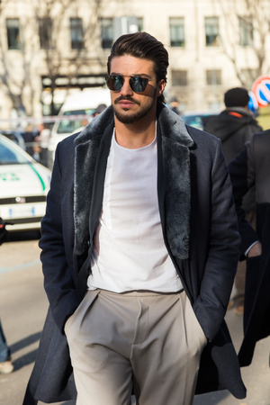 MILAN, ITALY - JANUARY 18: People gather outside Armani fashion show building for Milan Men's Fashion Week on JANUARY 18, 2016 in Milan.のeditorial素材
