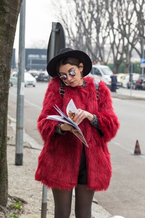 MILAN, ITALY - FEBRUARY 26: Fashionable woman outside Emporio Armani fashion show during Milan Women's Fashion Week on FEBRUARY 26, 2016 in Milan.のeditorial素材