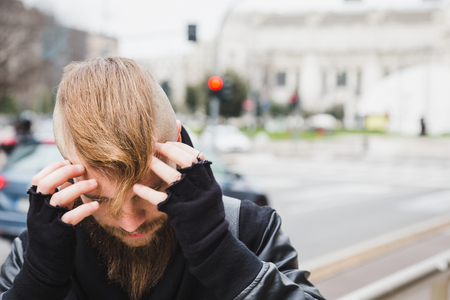 Stylish young bearded man posing in an urban contextの写真素材