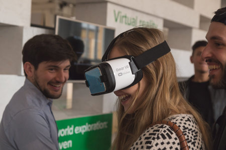 MILAN, ITALY - APRIL 13: Girl wears virtual reality headset at Fuorisalone, set of events...