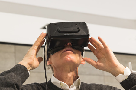 MILAN, ITALY - APRIL 13: Man wears virtual reality headset at Fuorisalone, set of events distributed in different areas of the town during Milan Design Week on APRIL 13, 2016 in Milan.のeditorial素材