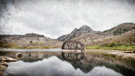 Vintage look picture of an alpine lake with mountains in north Portugalの写真素材
