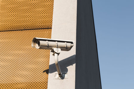Detail of a security camera on the corner of a modern building