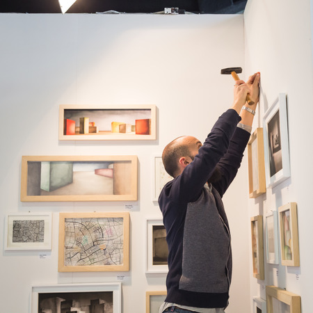 MILAN, ITALY - APRIL 29: Exhibitor in his stand at MIA, international photography and moving image art fair on APRIL 29, 2016 in Milanのeditorial素材