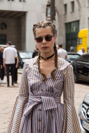 MILAN, ITALY - JUNE 19: Fashionable woman poses outside Ferragamo fashion show building during Milan Men's Fashion Week on JUNE 19, 2016 in Milan.のeditorial素材