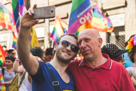MILAN, ITALY - JUNE 25: People at Pride parade in Milan JUNE 25, 2016. Thousands of people march in the city streets for the annual Pride parade, claiming equality and legal rights.のeditorial素材